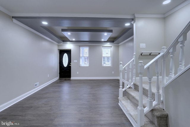 entryway featuring dark wood-type flooring and a tray ceiling