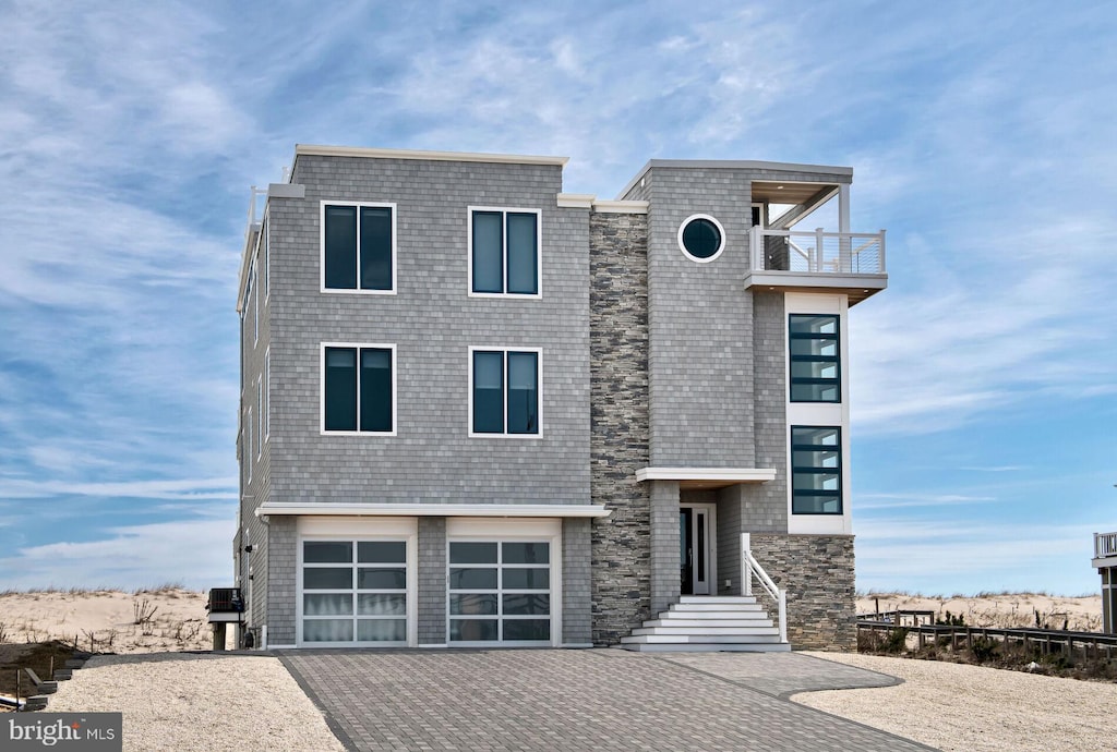 modern home featuring a garage and central air condition unit