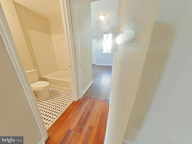 bathroom with wood-type flooring and toilet