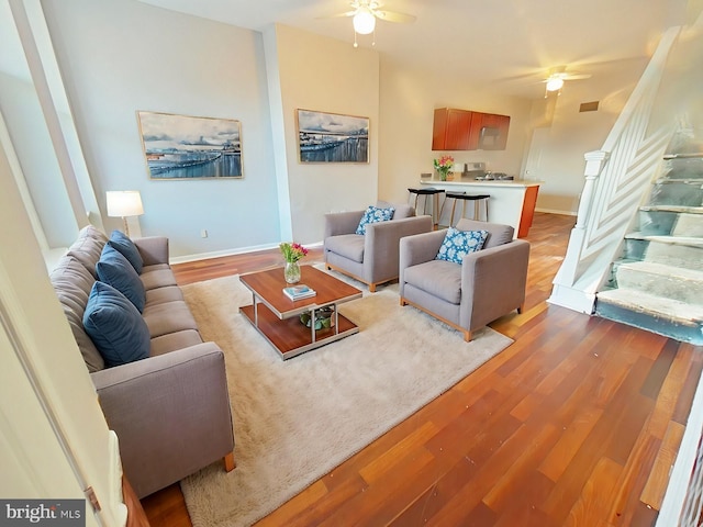 living room with hardwood / wood-style flooring and ceiling fan