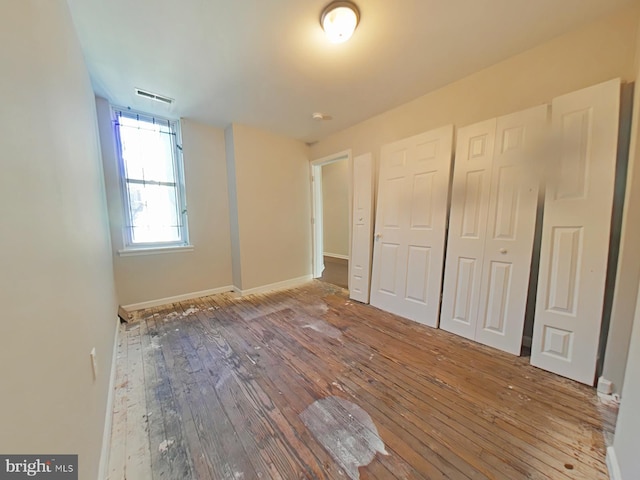 unfurnished bedroom featuring wood-type flooring