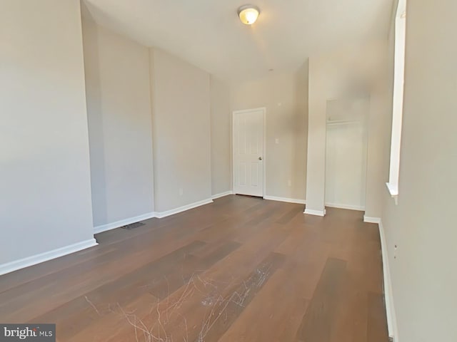 unfurnished room with dark hardwood / wood-style floors