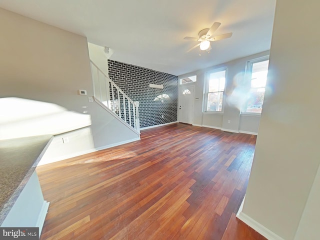 unfurnished living room with ceiling fan and hardwood / wood-style floors