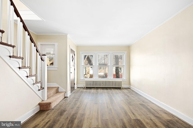 entryway featuring radiator, crown molding, and dark wood-type flooring