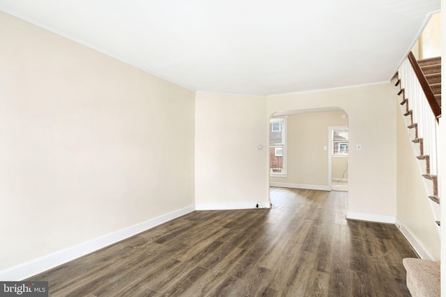 spare room featuring dark wood-type flooring