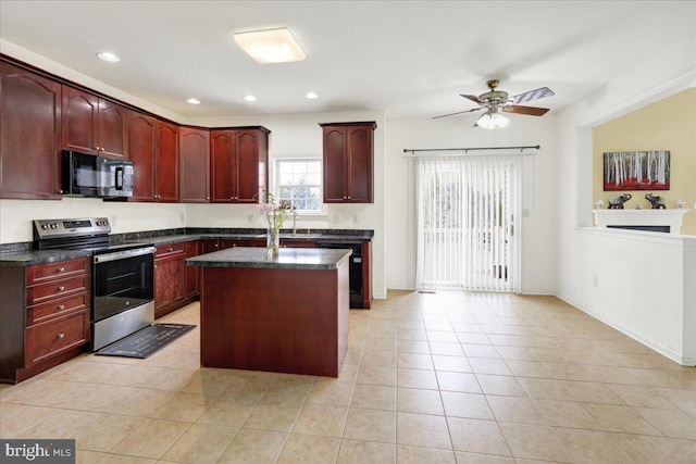 kitchen with ceiling fan, a kitchen island, black appliances, and light tile patterned floors