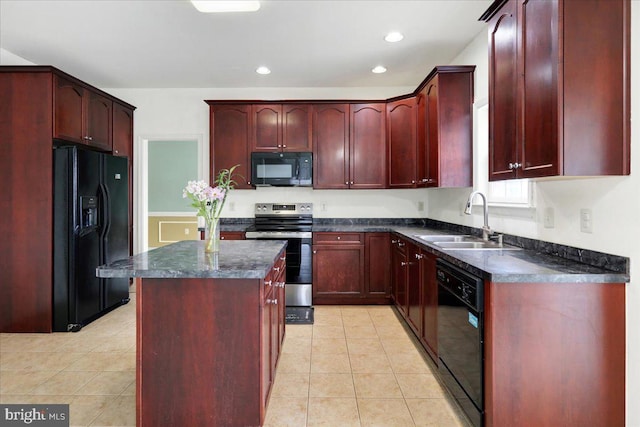 kitchen with a center island, light tile patterned floors, black appliances, and sink