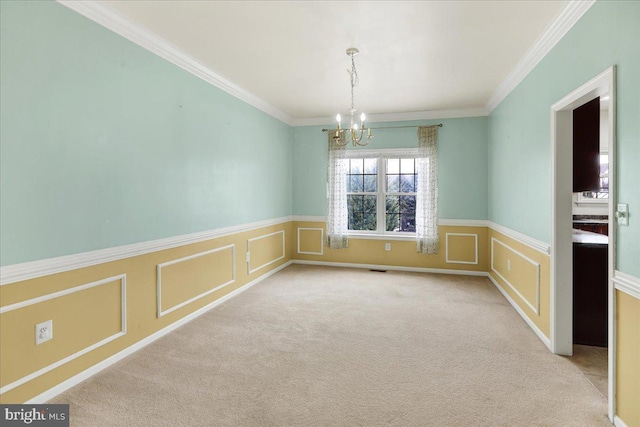 spare room with ornamental molding, light carpet, and an inviting chandelier