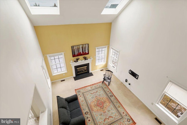 carpeted living room featuring high vaulted ceiling