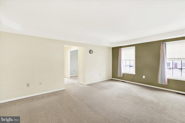 unfurnished room with light carpet