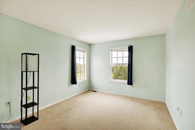 unfurnished room featuring light colored carpet