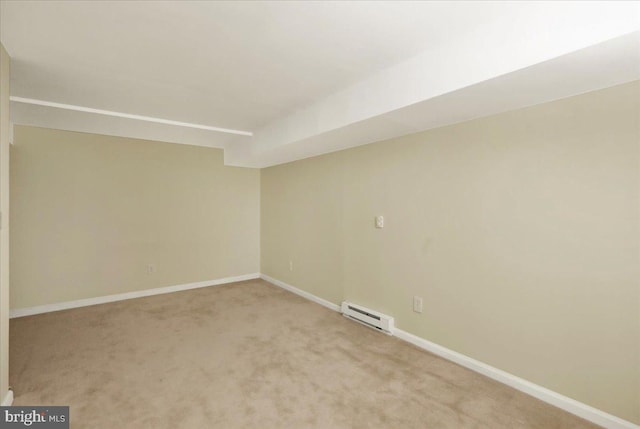 basement featuring light carpet and a baseboard radiator