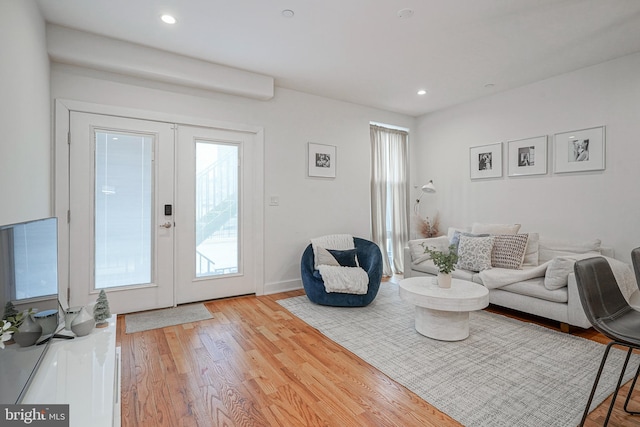 living room featuring light hardwood / wood-style flooring and french doors