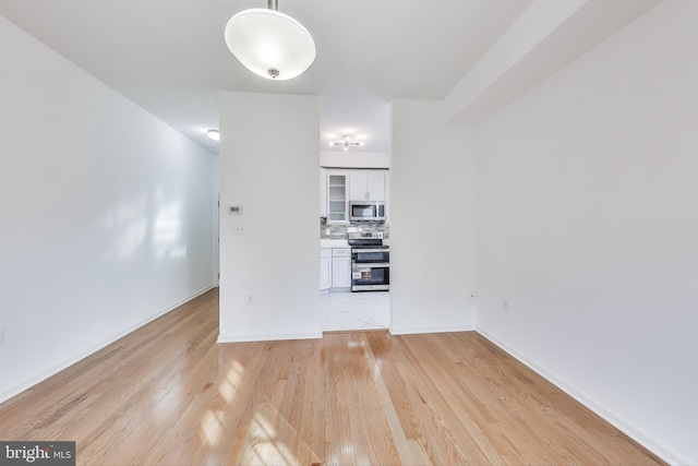 unfurnished living room with light wood-type flooring