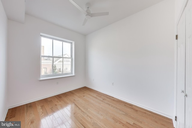 empty room with ceiling fan and light hardwood / wood-style floors