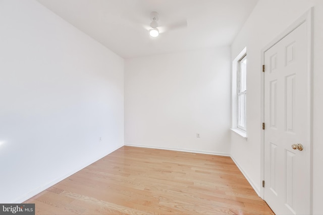 empty room with ceiling fan and light hardwood / wood-style floors