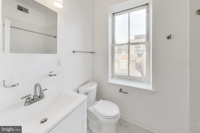 bathroom featuring vanity and toilet