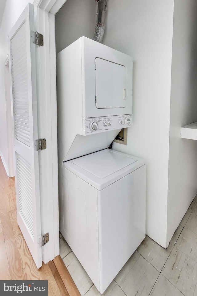 laundry area featuring stacked washer and clothes dryer