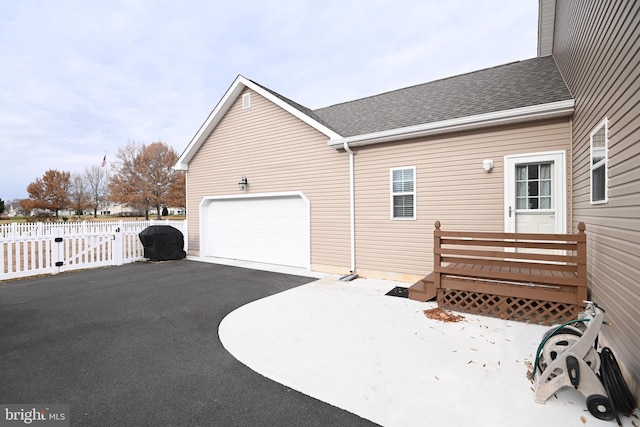 view of property exterior with a garage