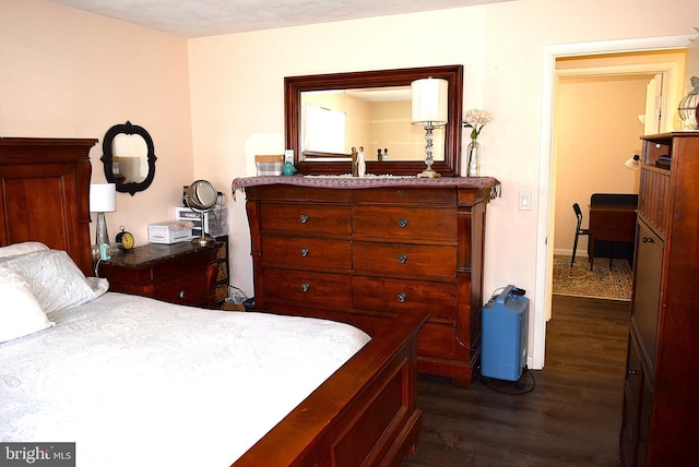 bedroom with dark wood-type flooring