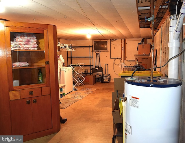 basement featuring electric water heater and washer / clothes dryer