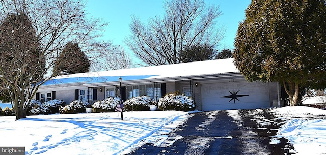 ranch-style home featuring a garage