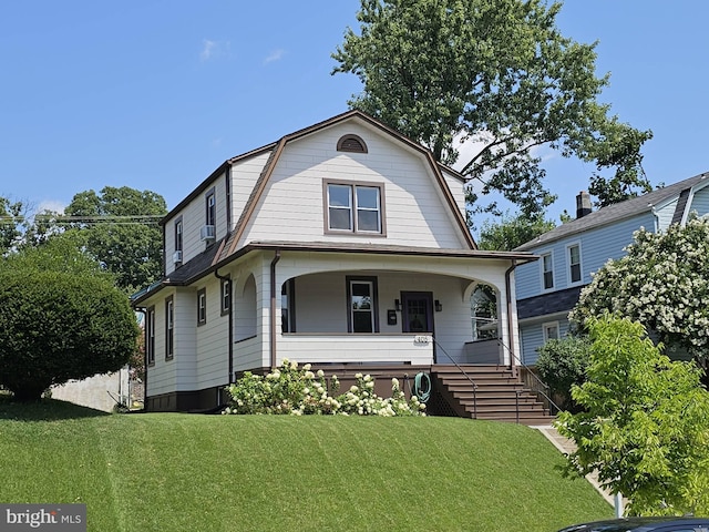 view of front of house with a porch and a front lawn