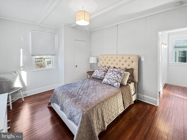 bedroom featuring beamed ceiling, dark hardwood / wood-style floors, and ornamental molding