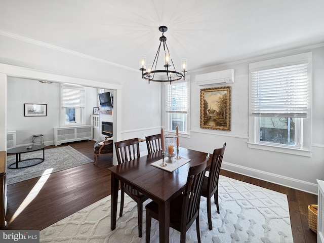 dining space featuring an AC wall unit, radiator heating unit, a healthy amount of sunlight, and an inviting chandelier