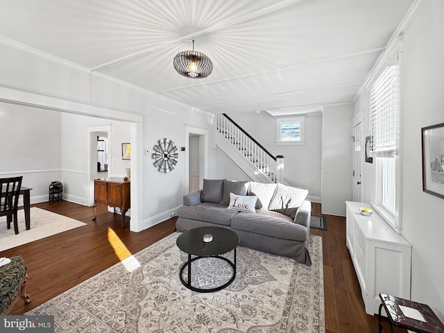 living room featuring ornamental molding and dark wood-type flooring