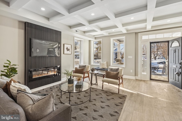 living room with beam ceiling, coffered ceiling, and hardwood / wood-style flooring