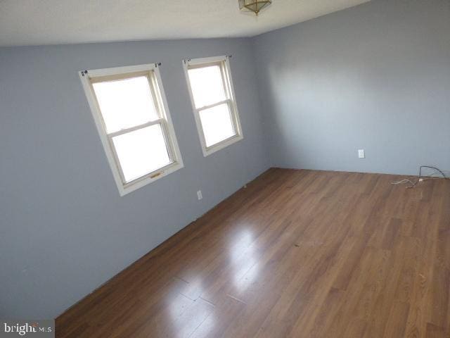 spare room with hardwood / wood-style floors