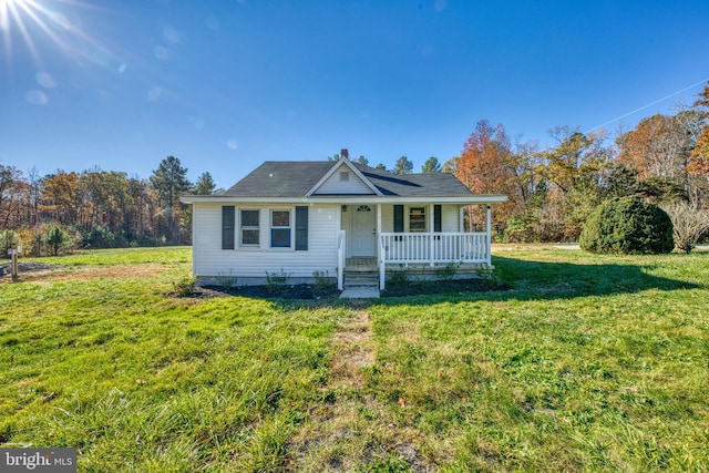 view of front of home with covered porch and a front yard