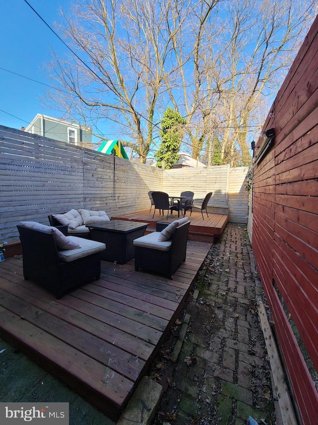 wooden deck with an outdoor living space