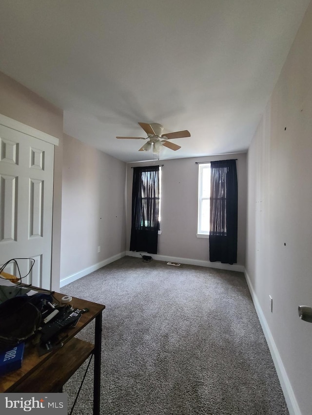 spare room with carpet and ceiling fan