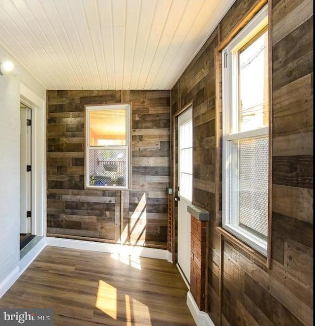 interior space featuring wood walls, dark wood-type flooring, and wood ceiling