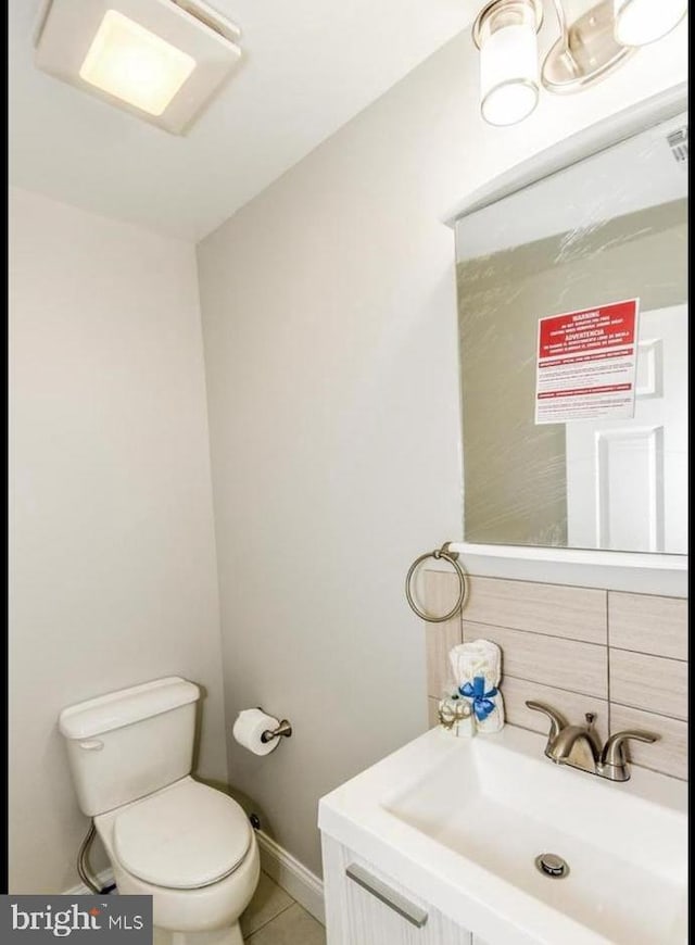 bathroom with tile patterned flooring, toilet, and sink