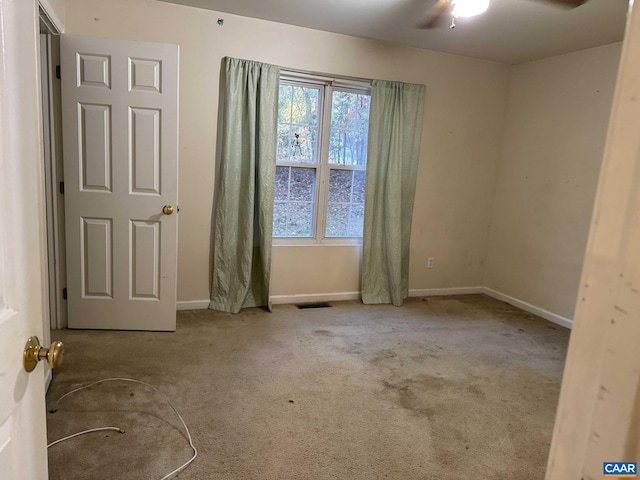 carpeted empty room with ceiling fan