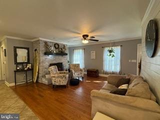 living room featuring hardwood / wood-style flooring, ceiling fan, and ornamental molding