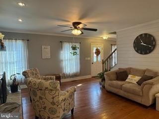 living room featuring ceiling fan, dark hardwood / wood-style flooring, and crown molding