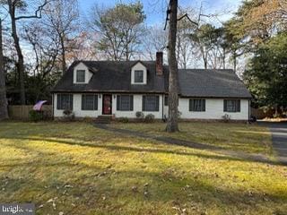 new england style home featuring a front yard