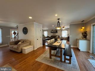 dining space featuring dark hardwood / wood-style flooring and crown molding