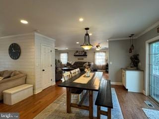 dining room featuring hardwood / wood-style flooring and ornamental molding