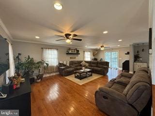 living room with ceiling fan, wood-type flooring, and ornamental molding