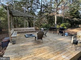 wooden deck with a fire pit