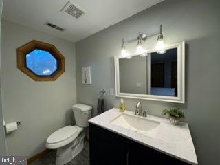 bathroom with vanity and toilet