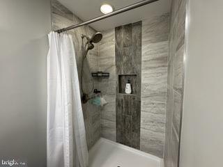 bathroom featuring curtained shower