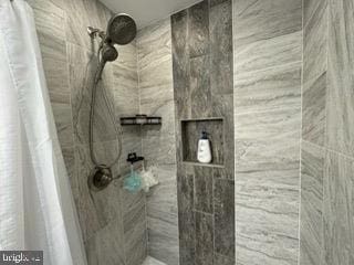 bathroom with tiled shower