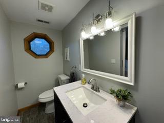 bathroom featuring vanity and toilet