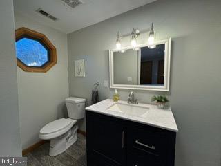 bathroom featuring vanity and toilet